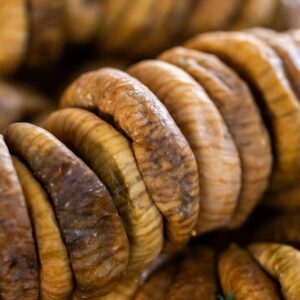 A detailed close-up image of stacked dried figs showcasing texture and color.