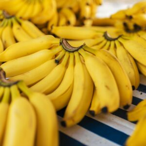 Bunches of ripe yellow bananas displayed on a market stall. Perfect for healthy eating concepts.