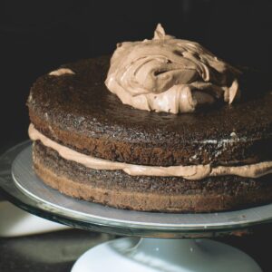 Decadent chocolate layer cake with rich frosting on display. Ideal for dessert lovers.